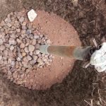 Stones, rocks are filled in recharge pit for proper water filtration.