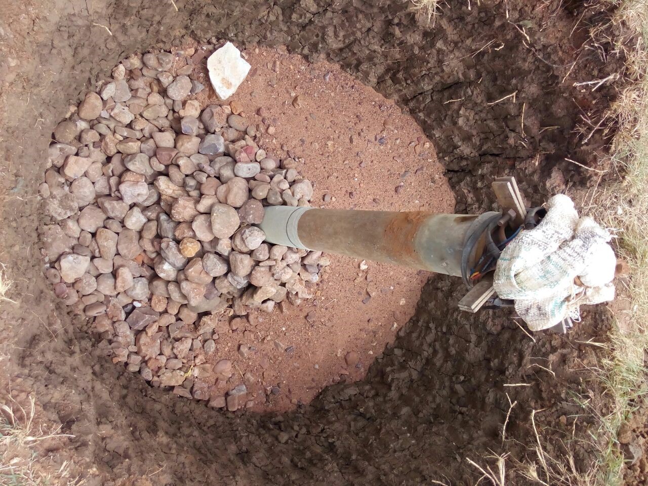 Stones, rocks are filled in recharge pit for proper water filtration.